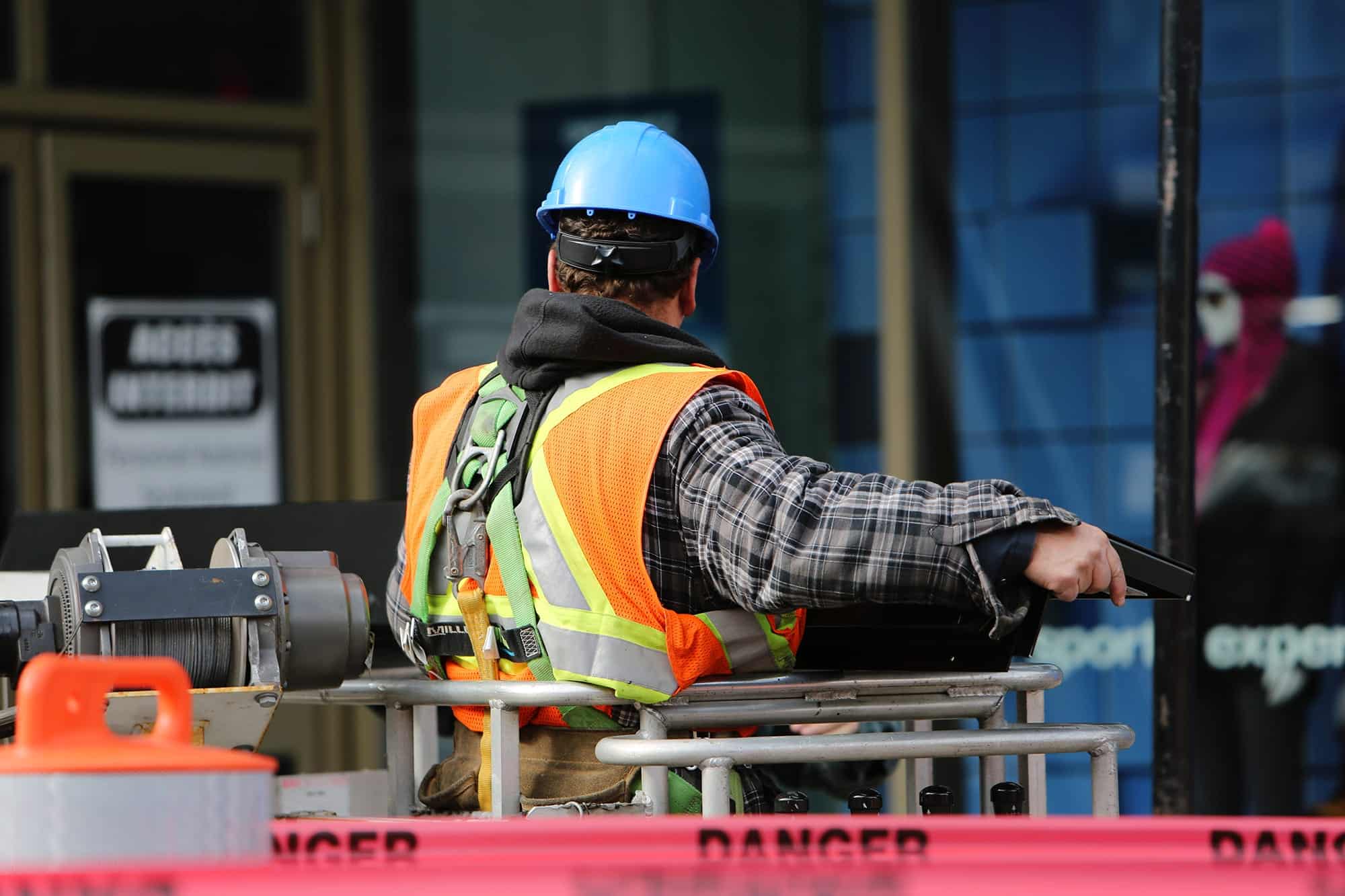 An occupational therapy construction worker wearing a hard hat and safety vest.